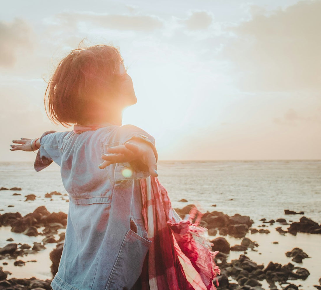 Woman enjoying sunshine outdoors, a natural source of vitamin D