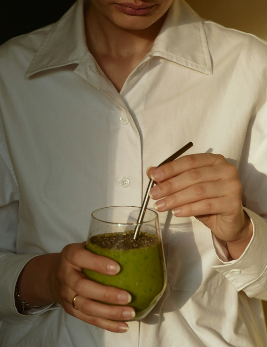 Woman drinking a healthy smoothie for glowing skin
