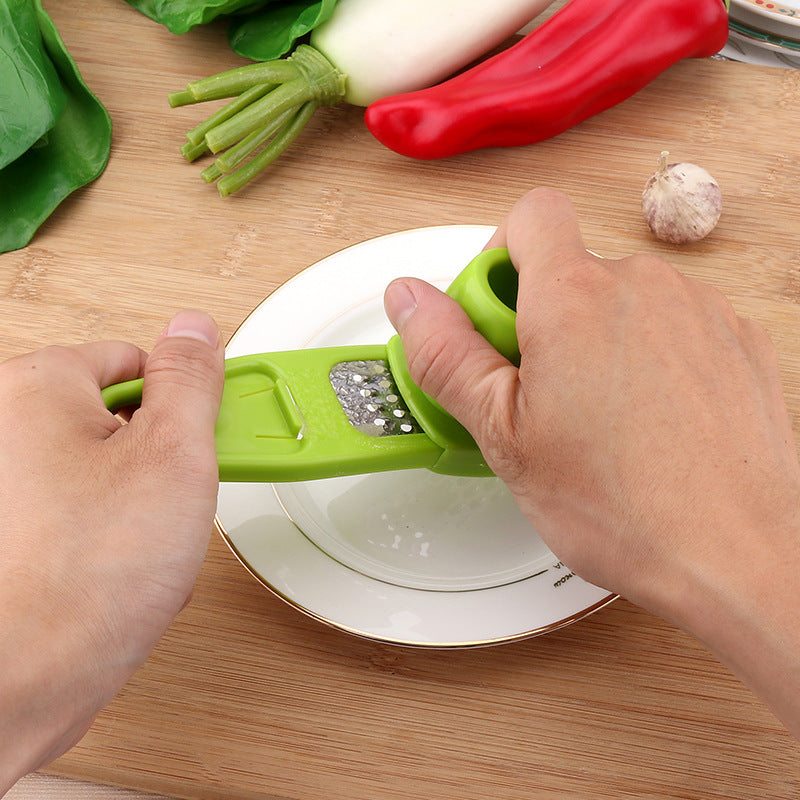 Manual garlic press and seasoning grinder
